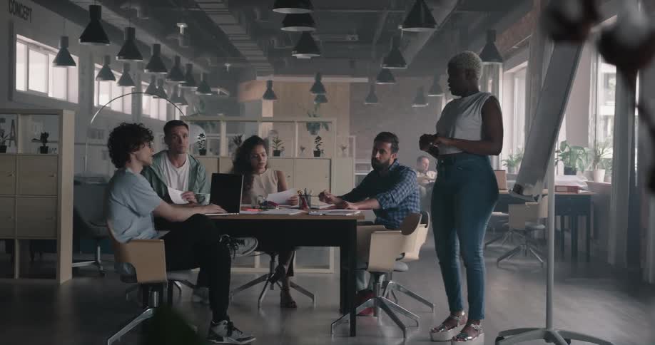 Colleagues take notes during a meeting at the office
