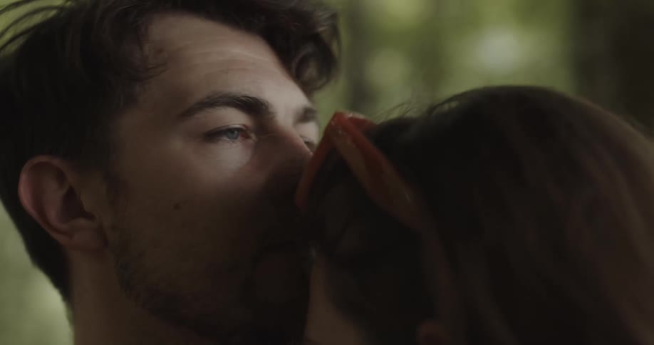 Close up of a man consoling his partner with a hug and kisses on her forehead