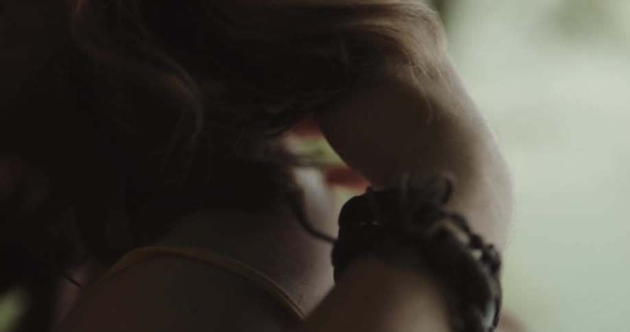 Close up of a man consoling his partner with a hug while caressing her hair