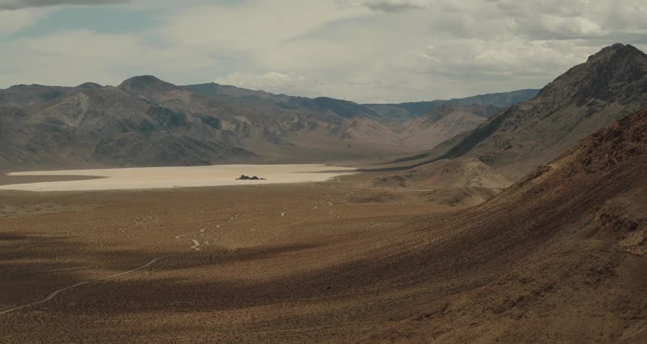 Aerial view of the sands of a desert in the valley between mountains