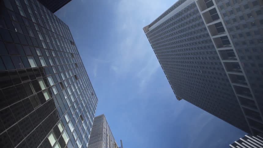 Looking up in a city at tall buildings