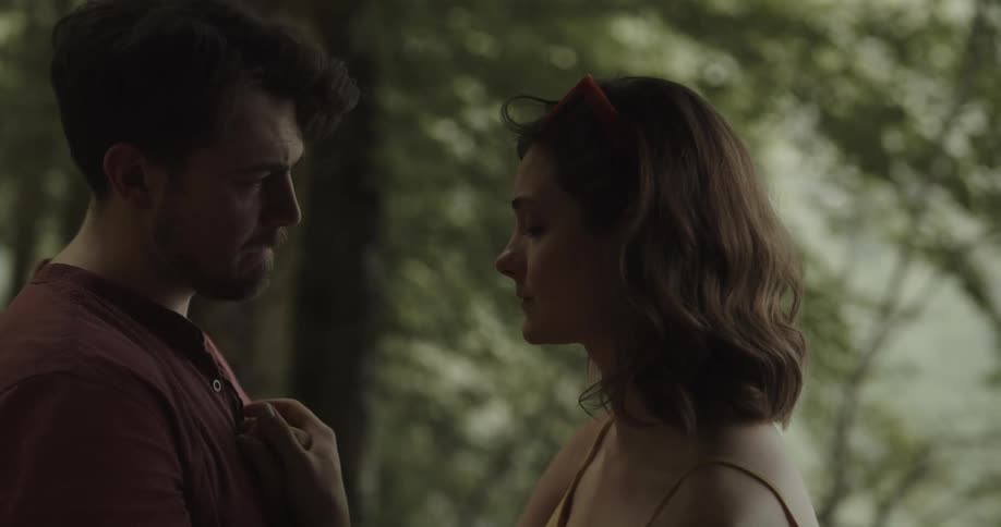 A woman who is upset is consoled my her male companion outdoors