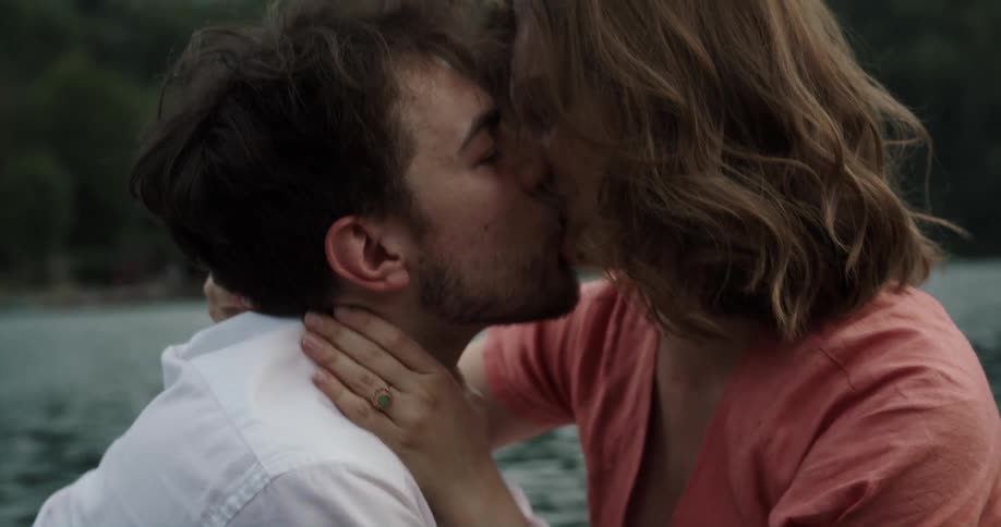 Woman and man are kissing in the water during the spring time