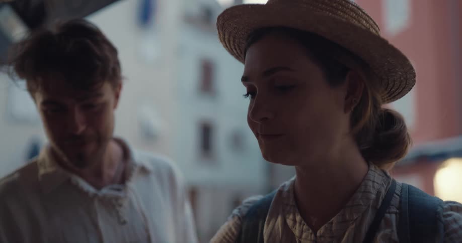 Young couple on vacation eating berries from a street vendor on a small town