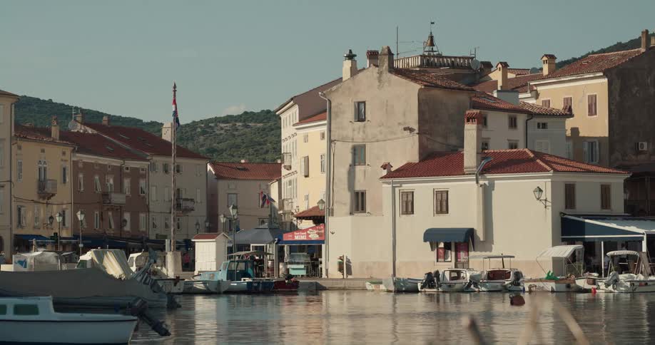 Boats floating in a marina new town buildings