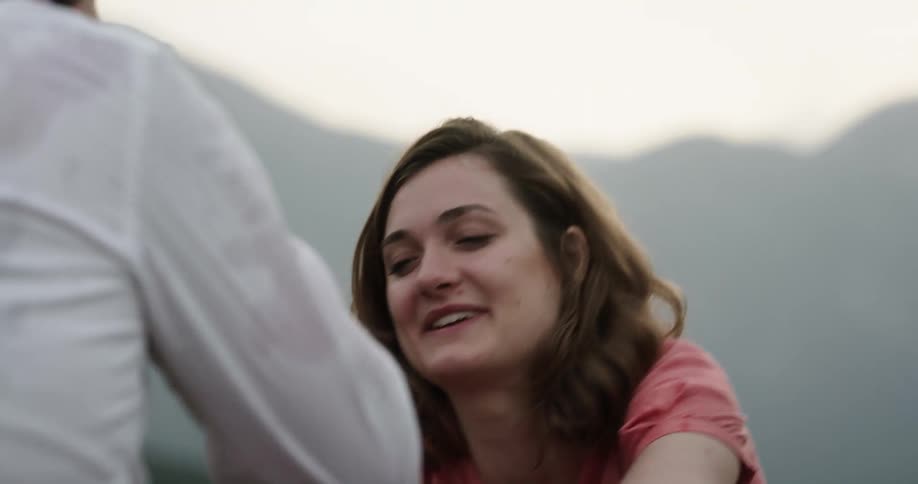 Woman splashes water on her boyfriend as she laughs