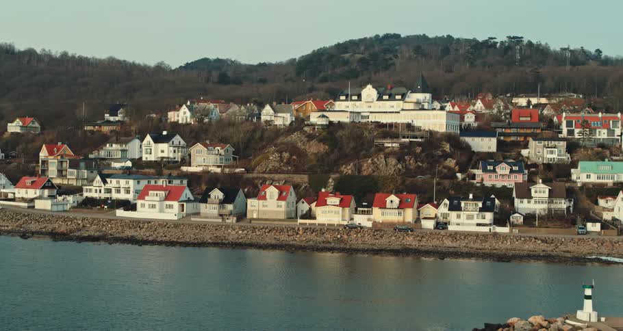 House and buildings on the coastline of a town near the ocean during the day