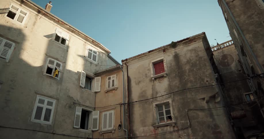 Numerous residential apartment buildings with dirty facades are crowded together