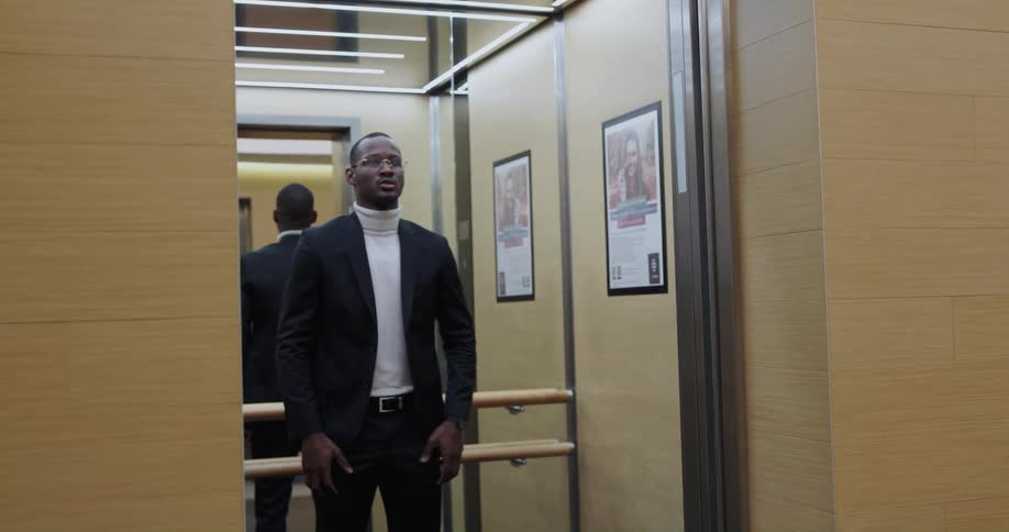 A man walking into an elevator