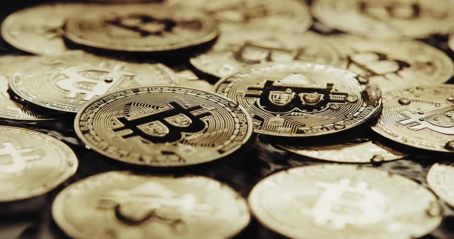 Water droplets are moving across gold bitcoins in water