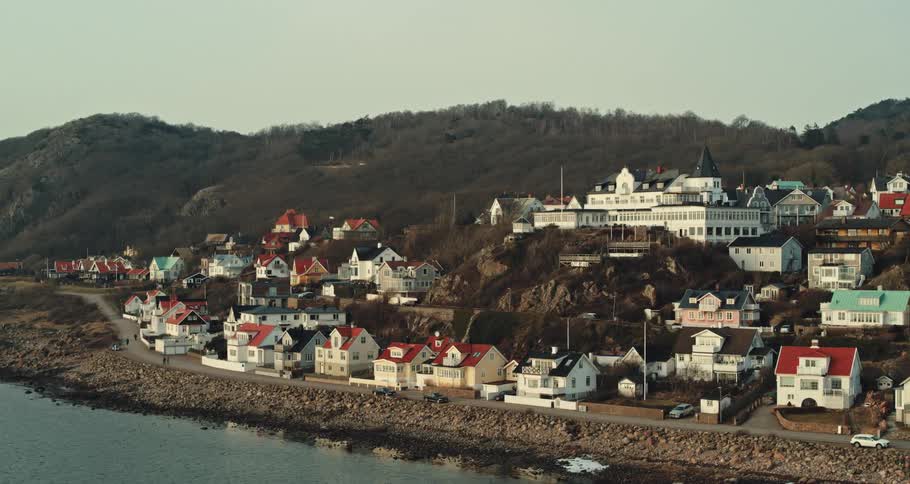 Homes with colorful roofs fill a neighborhood along the coast