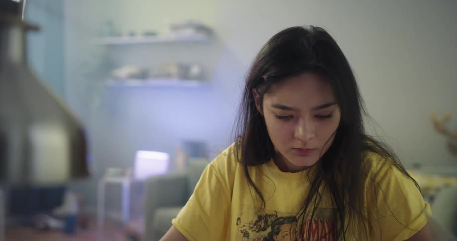 A woman sitting in a room reading papers