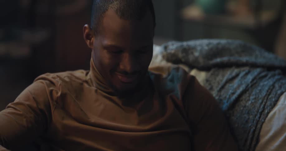 A man looks at his cell phone at home
