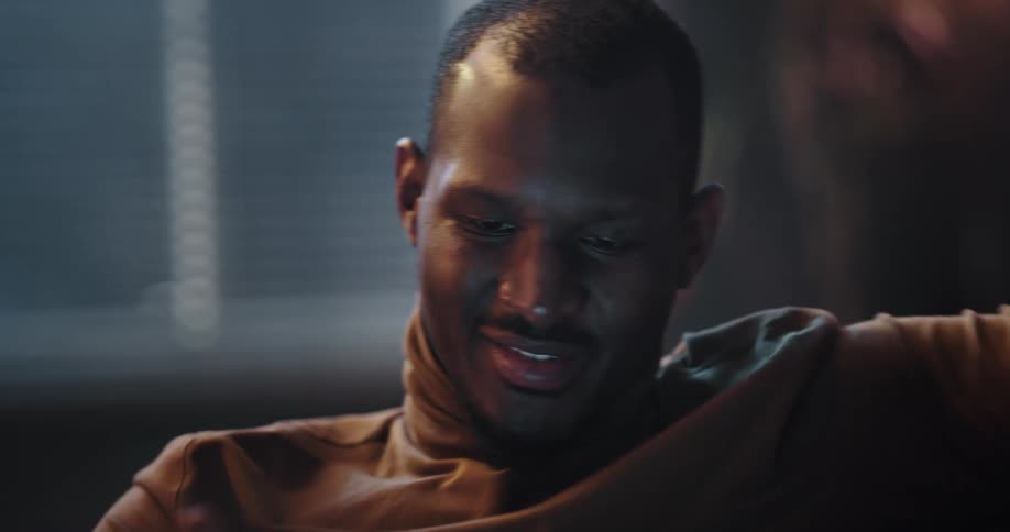 A man is sitting indoors in his house