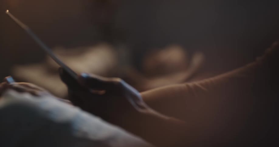 A person is texting on a cellphone at night