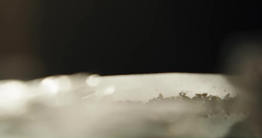 Close up of a man filling smoking paper with finely cut tobacco