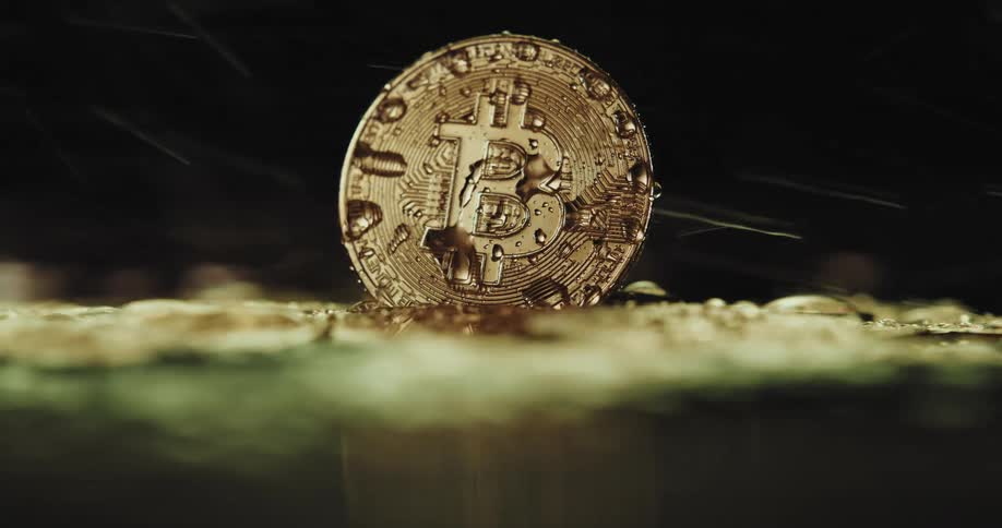 Pressurized water is sprayed on a gold coin