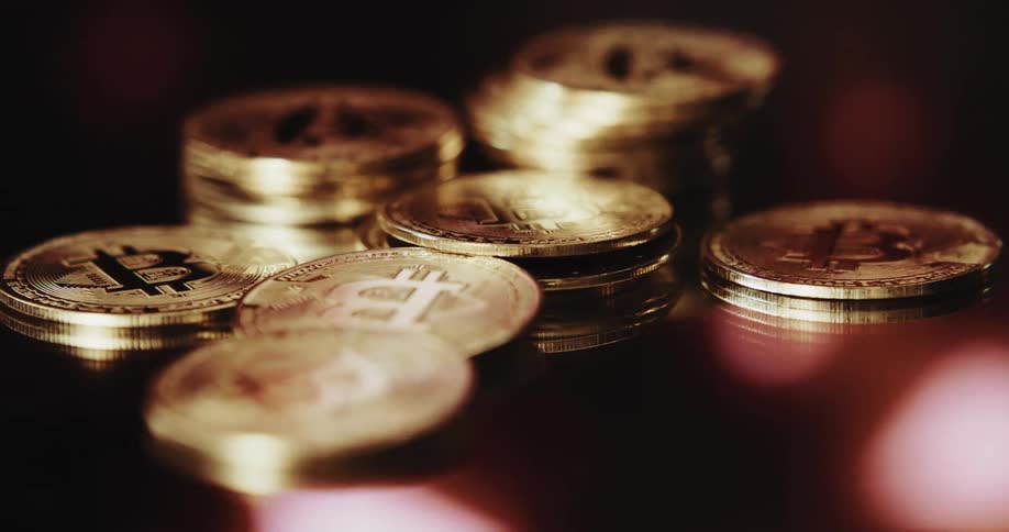 Stack of golden coins printed with the bitcoin logo in them