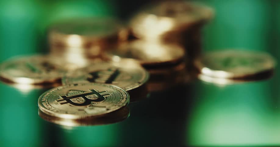 Stack of golden coins with the bitcoin logo printed on them
