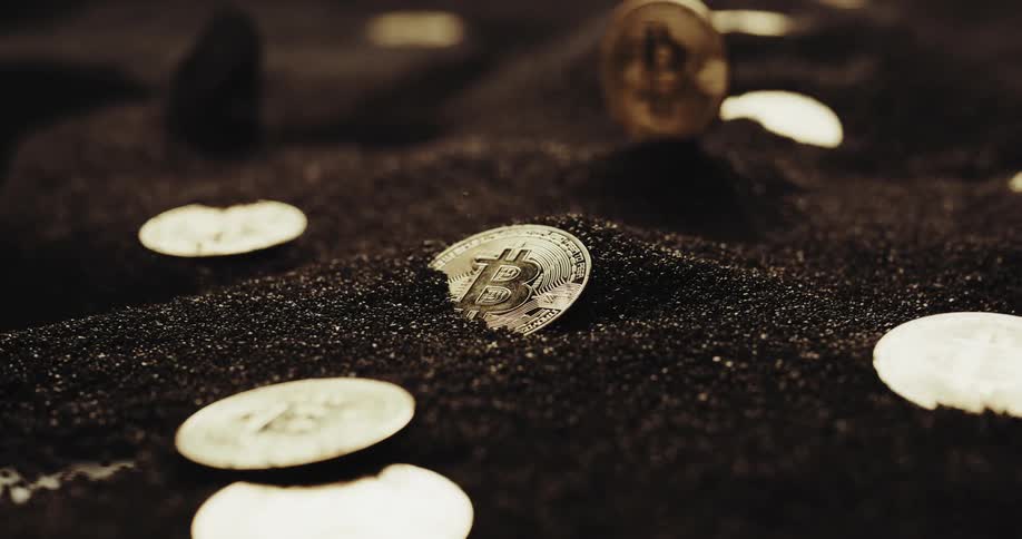 Black dirt falls on the round coins that have an upper case b on them