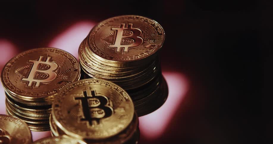 Stack of golden coins with the bitcoin logo printed on them