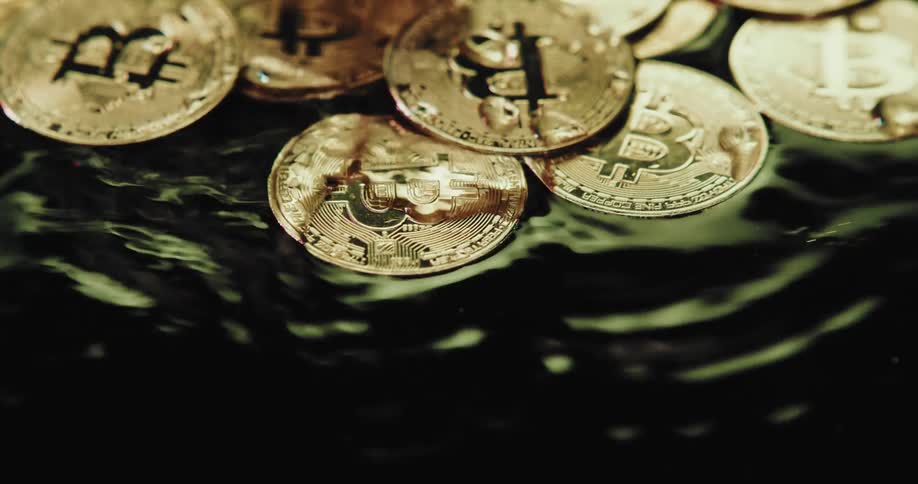 Water rippling over coins in a river