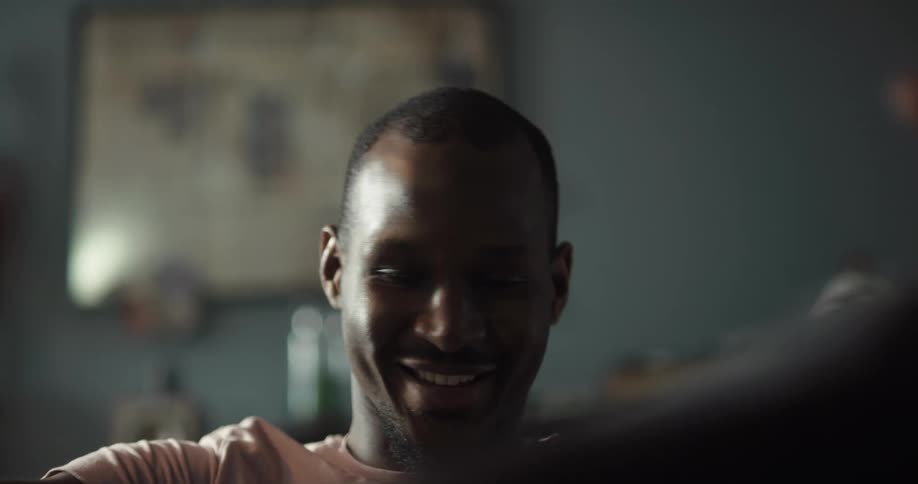 A man sitting in a room listening to music