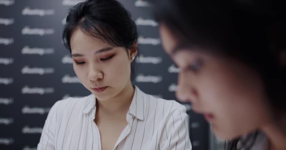 Two coworkers talking in a room
