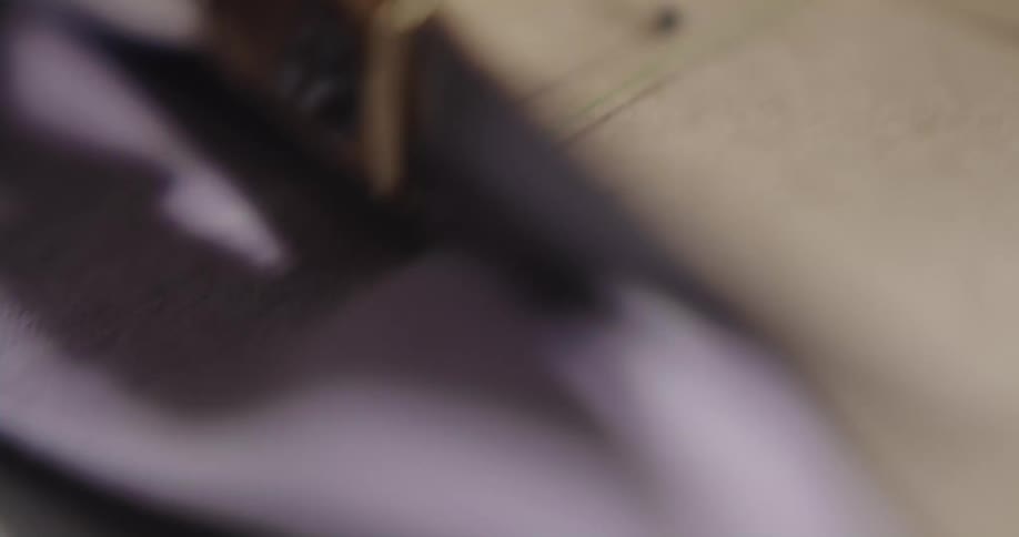Pins hold fabric in place as it is being cut with scissors