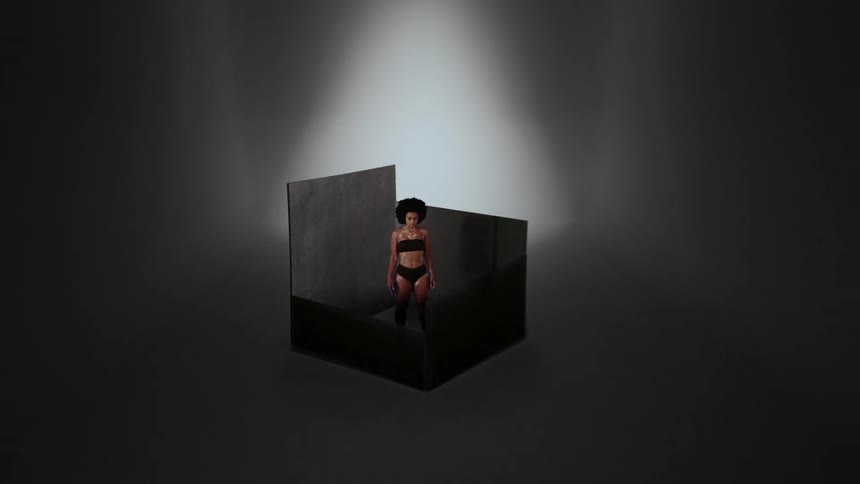 A digital box rises around a woman to confine her
