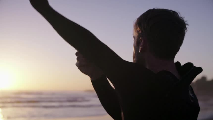 A man puts on a wet suit