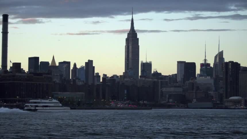 A city near the water at dusk