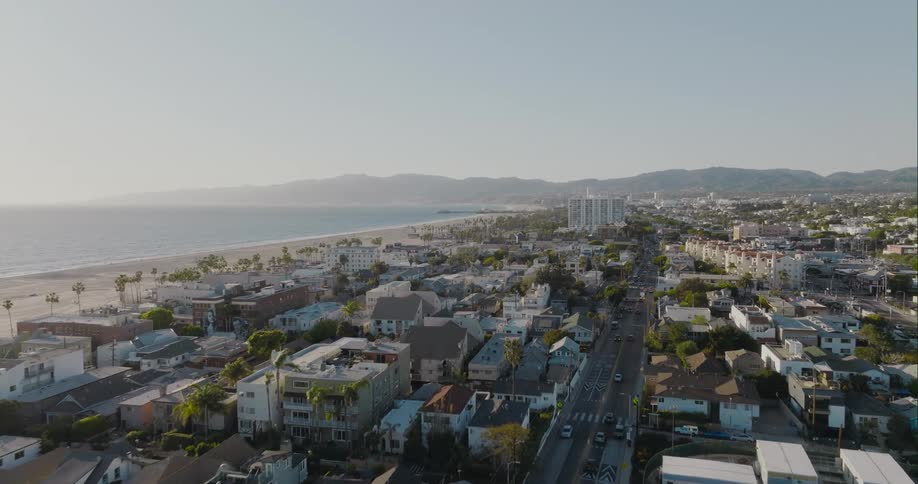 Aerial view of a waterfront city near to the beach near the ocean at morning