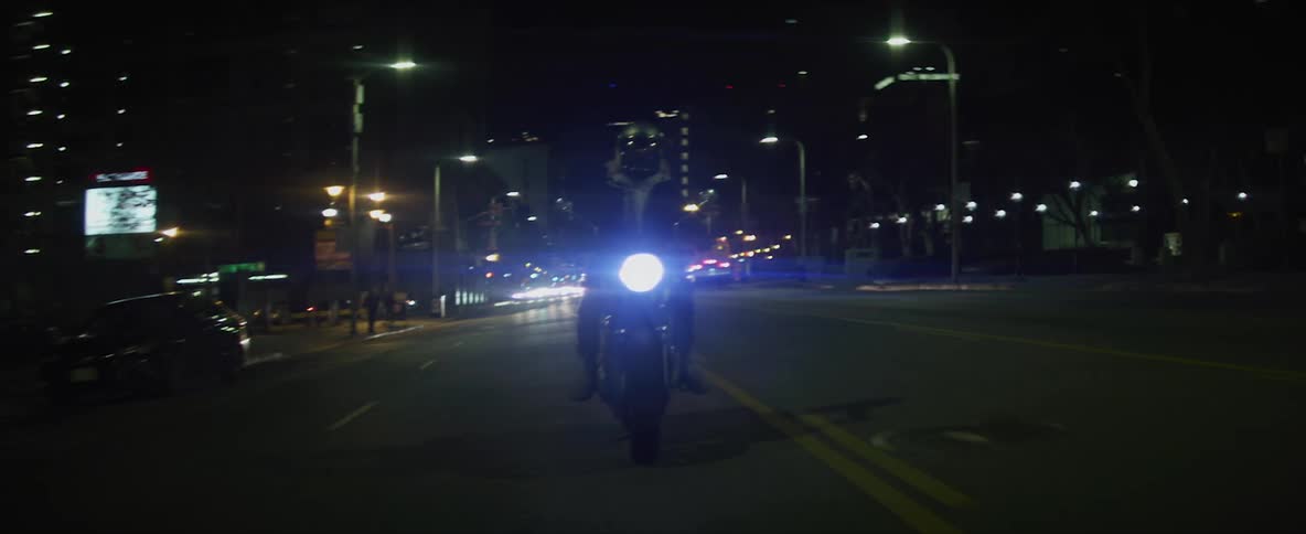Biker rides motorcycle on highway at night