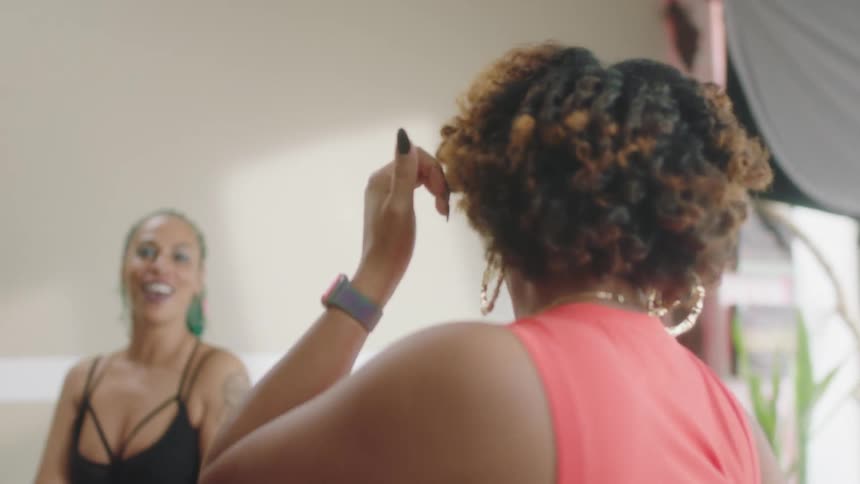 Group of 4 women move their arms around as they dance
