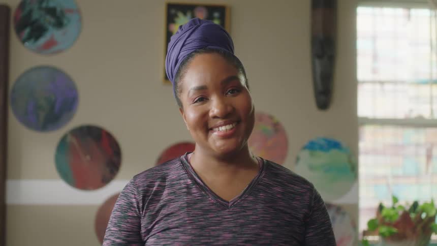 A woman poses for the camera and gives a very big smile