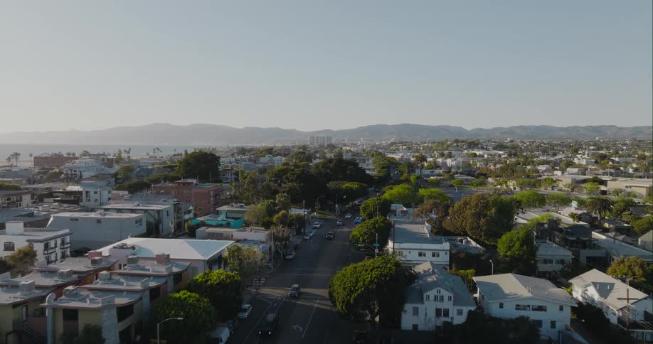 Traffic moves down tree lined streets of a small city