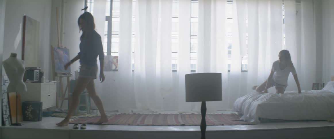 Two women get up from bed and walk away
