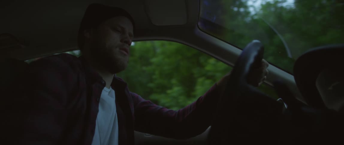 Angry man driving a car and punching the steering wheel