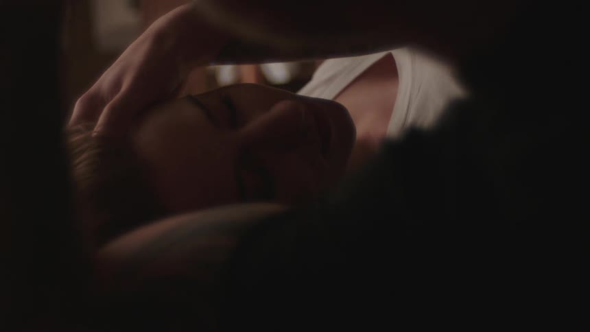 While lying down together man strokes womans hair