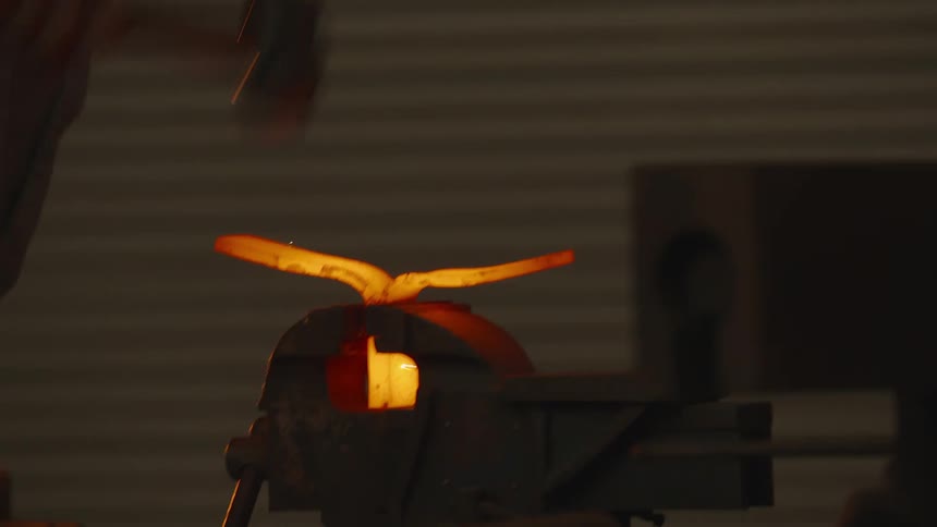 A man hammering metal