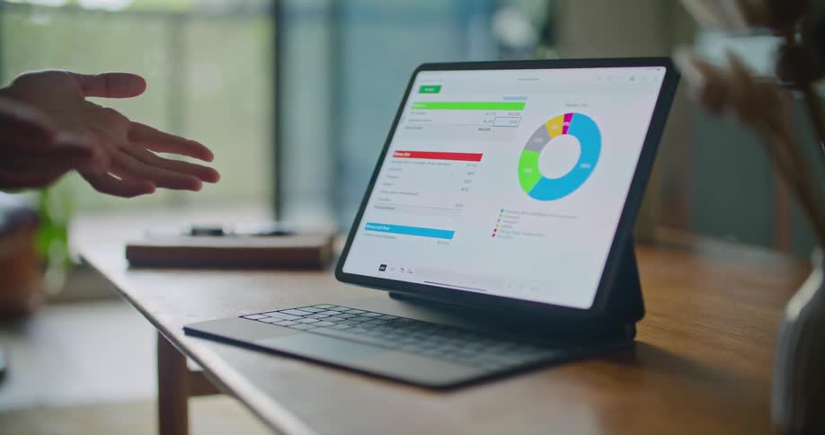 Diagram on a computer monitor with a keyboard in front of it and two pairs of hands motioning to the monitor