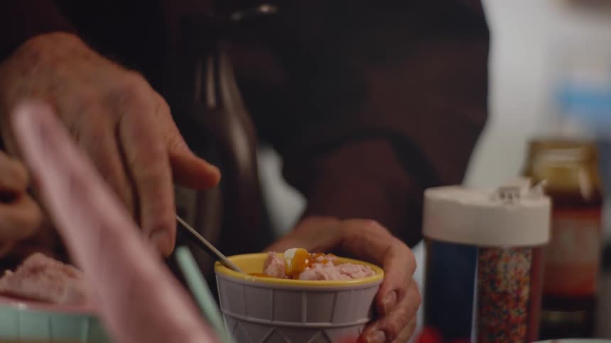 People making ice cream sundaes