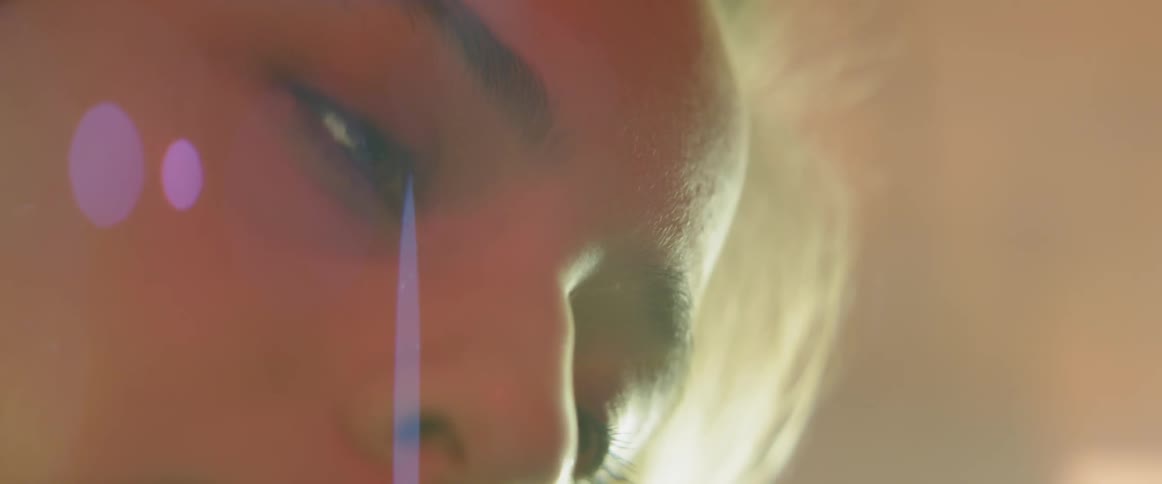Close up of a woman's face and bright light