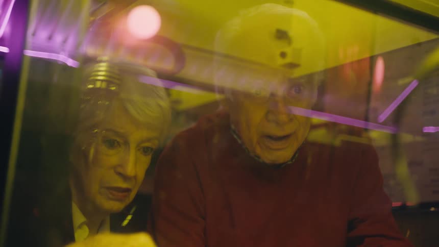 A man and woman are playing an arcade game together