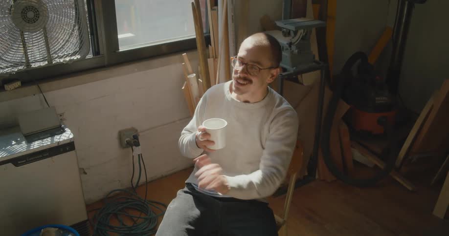 An artist sits and drinks coffee