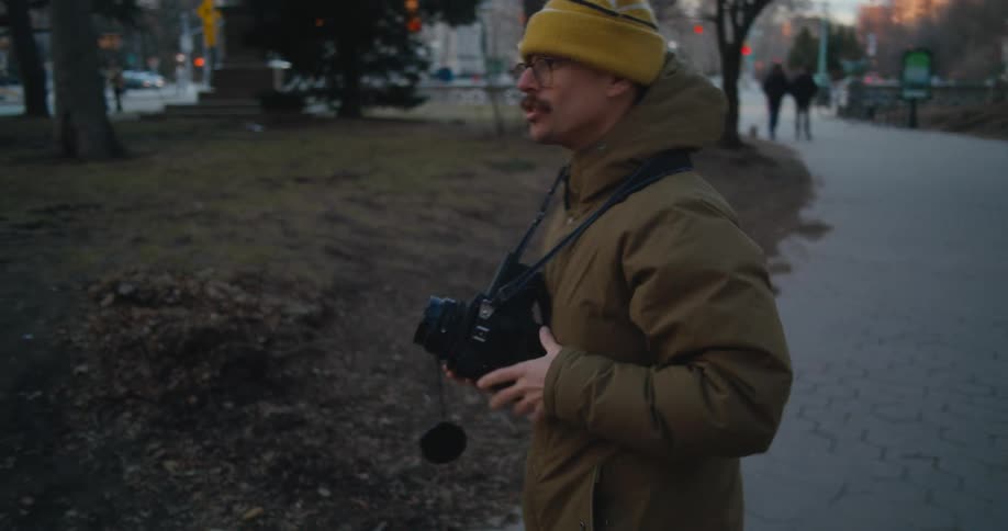 Male cameraman takes pictures in park then signs a thank you