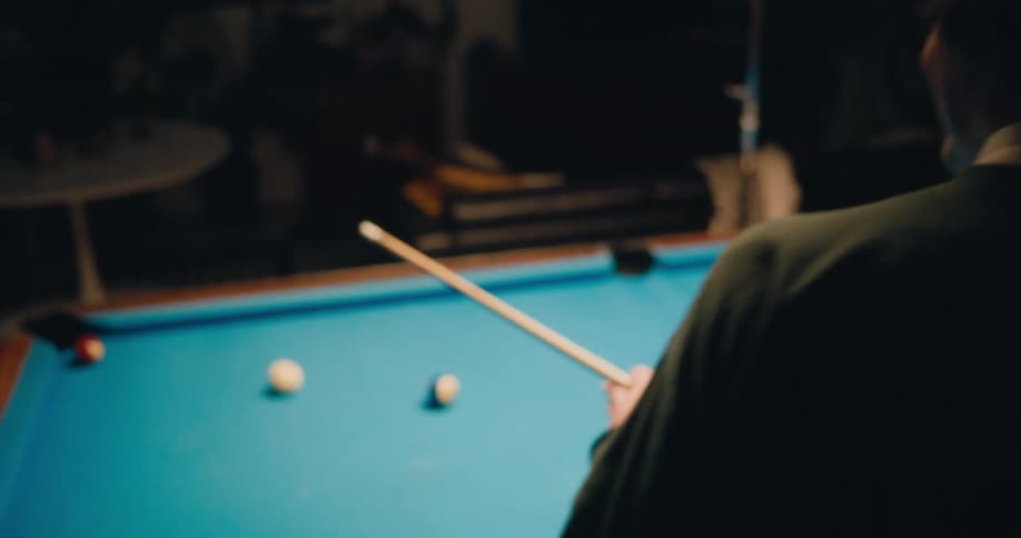 Two friends are playing a game of billiards pool together