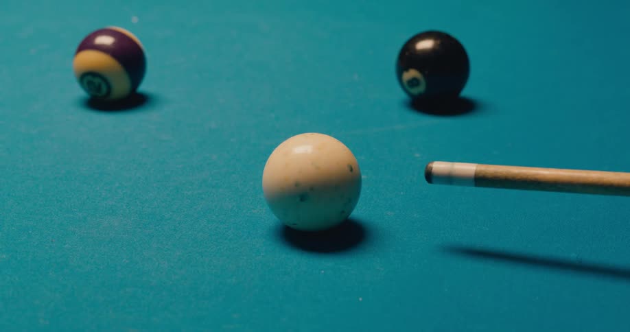 A person is playing a game of pool