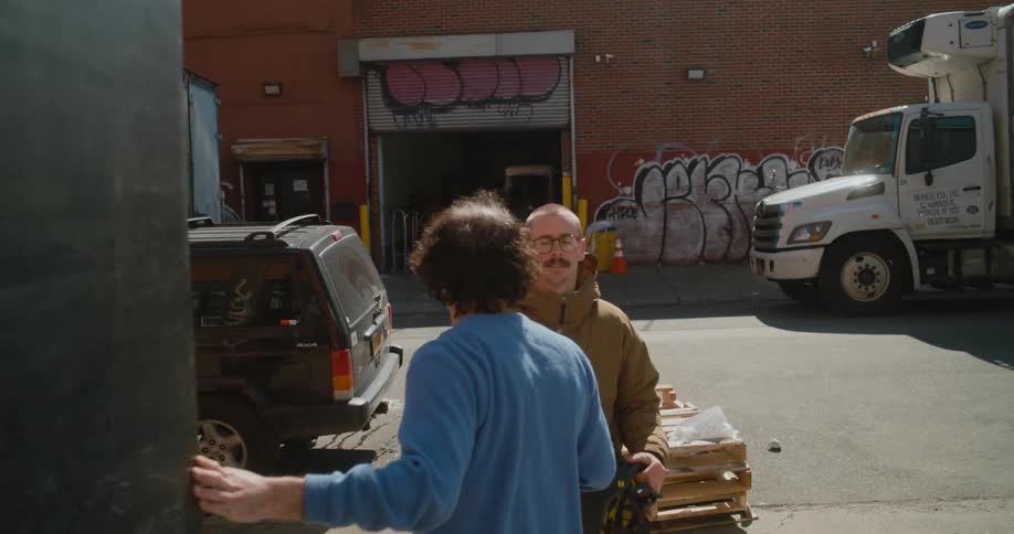 Two men walk down the alley together